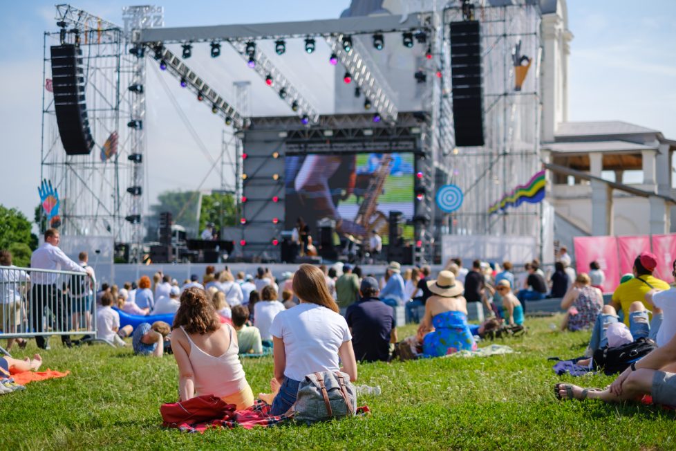 Couple is watching concert at open air music festival